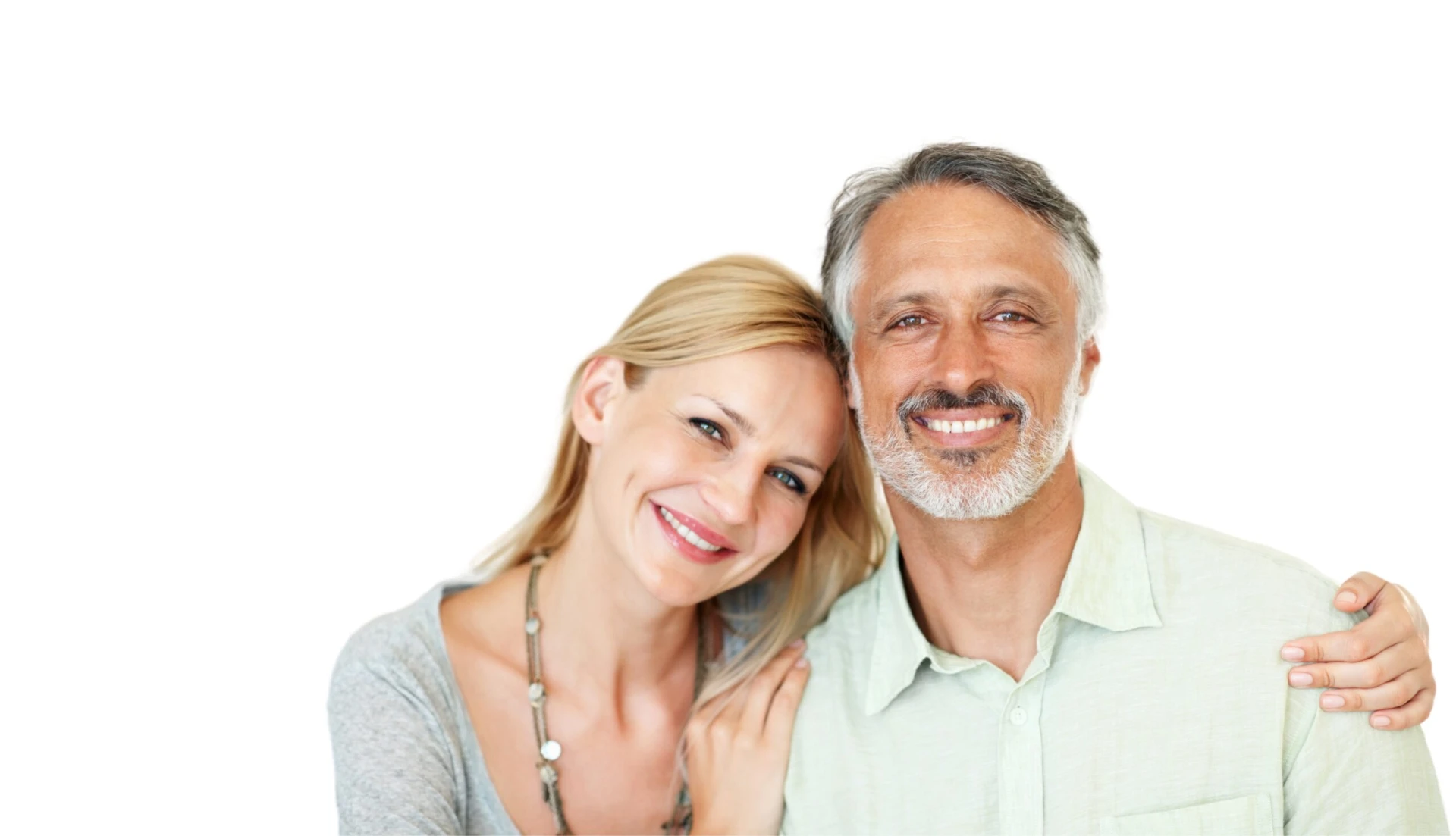 Smiling couple after full mouth dental implant treatment